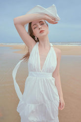 Silk halter maxi dress with deep V neckline and tiered skirt for elegant resort wear