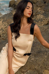 Sleeveless silk midi dress with contrast straps and back bow detail for elegant styling