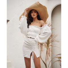 Silk blouse with off-shoulder neckline and ruched puff sleeves paired with ruched silk skirt