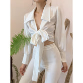 Silk blouse with exaggerated collar, front tie detail, and long puff sleeves with wide cuffs