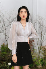 High-waisted pleated silk skirt with elegant flow and tailored waistband for refined styling