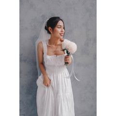 Sleeveless silk organza dress with shirred bodice and tiered hem for effortless elegance