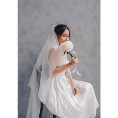 Sleeveless silk organza dress with shirred bodice and tiered hem for effortless elegance