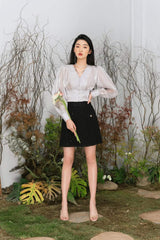 High-waisted pleated silk skirt with elegant flow and tailored waistband for refined styling