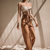 Silk crop top with front tie detail and adjustable shoulder straps for a sleek summer look