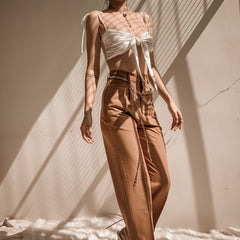 Silk crop top with front tie detail and adjustable shoulder straps for a sleek summer look