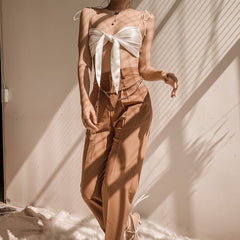 Silk crop top with front tie detail and adjustable shoulder straps for a sleek summer look