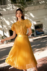 Silk blouse with pleated ruffle sleeves and pearl button front for elegant styling