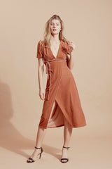 Velvet wrap midi dress with puff sleeves and deep V-neckline for elegant day-to-evening wear