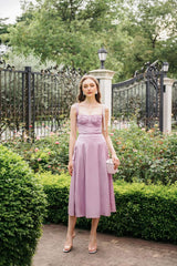 Silk midi dress with ruched bodice, wide straps, and flared skirt for elegant movement