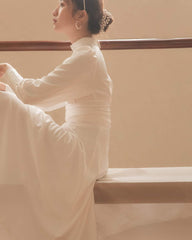 Silk midi dress with high neckline, keyhole detail, and long puff sleeves for refined elegance