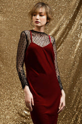 Velvet slip dress with figure-skimming fit and sheer lace sleeves for elegant layering looks
