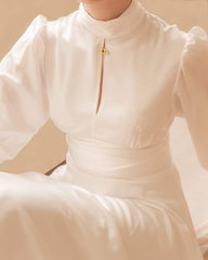 Silk midi dress with high neckline, keyhole detail, and long puff sleeves for refined elegance