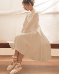 Silk midi dress with high neckline, keyhole detail, and long puff sleeves for refined elegance