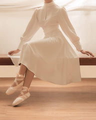 Silk midi dress with high neckline, keyhole detail, and long puff sleeves for refined elegance