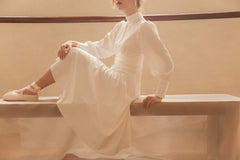 Silk midi dress with high neckline, keyhole detail, and long puff sleeves for refined elegance