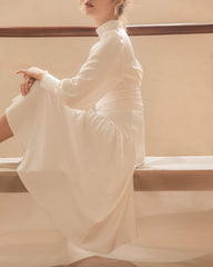 Silk midi dress with high neckline, keyhole detail, and long puff sleeves for refined elegance