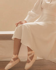 Silk midi dress with high neckline, keyhole detail, and long puff sleeves for refined elegance