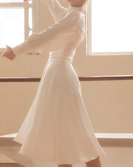 Silk midi dress with high neckline, keyhole detail, and long puff sleeves for refined elegance