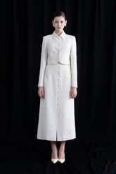 Structured bouclé midi skirt with front slit and fabric-covered buttons