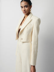 Textured wool-blend cropped jacket with peak lapels and structured shoulder tailoring