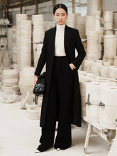 Wide-leg wool blend pants with tailored pleats and structured high-rise waistband