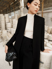 Tailored wool blend long coat with structured silhouette and minimalist open-front design