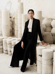 Tailored wool blend long coat with structured silhouette and minimalist open-front design
