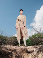 Tailored wool blend trench coat with oversized lapels and structured belted waist