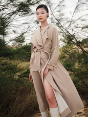 Tailored wool blend trench coat with oversized lapels and structured belted waist