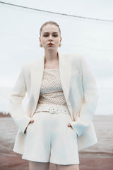 Structured longline blazer with sharp shoulders and a contoured waistline