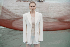 Structured longline blazer with sharp shoulders and a contoured waistline