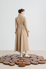 Tailored wool blend trench coat with oversized lapels and structured belted waist