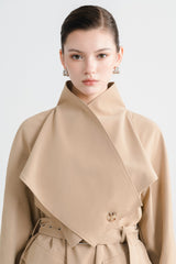 Tailored wool blend trench coat with oversized lapels and structured belted waist