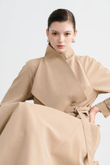 Tailored wool blend trench coat with oversized lapels and structured belted waist