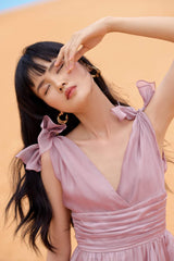Sleeveless silk maxi dress with deep V-neckline and high slit for elegant summer styling