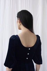 Velvet midi dress with puff sleeves and scoop neckline for elegant day-to-evening styling