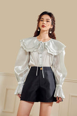 High-waisted linen cotton shorts with wide-leg cut and gold-tone button front detail