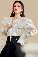 High-waisted linen cotton shorts with wide-leg cut and gold-tone button front detail