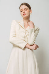 Textured wool cropped jacket with notch lapels and flap pockets