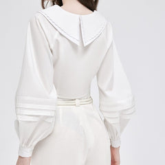 Silk blouse with oversized sailor collar and pleated lantern sleeves for feminine elegance