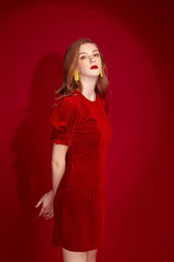 Velvet mini dress with puff sleeves and tailored silhouette for refined festive styling