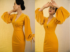 Velvet dress with plunging neckline and dramatic bishop sleeves for evening elegance