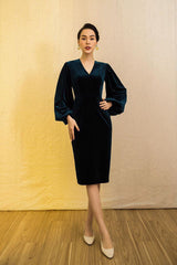 Velvet midi dress with voluminous long sleeves and structured V-neckline for evening wear