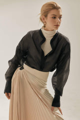 High-waisted pleated A-line skirt in flowing silk with structured waistband detail
