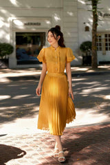 Silk blouse with pleated ruffle sleeves and pearl button front for elegant styling