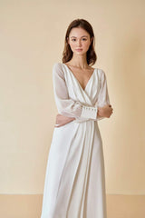 Silk maxi dress with sheer long sleeves and pleated wrap front for timeless elegance