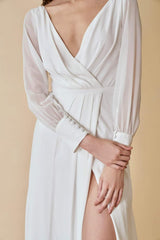 Silk maxi dress with sheer long sleeves and pleated wrap front for timeless elegance